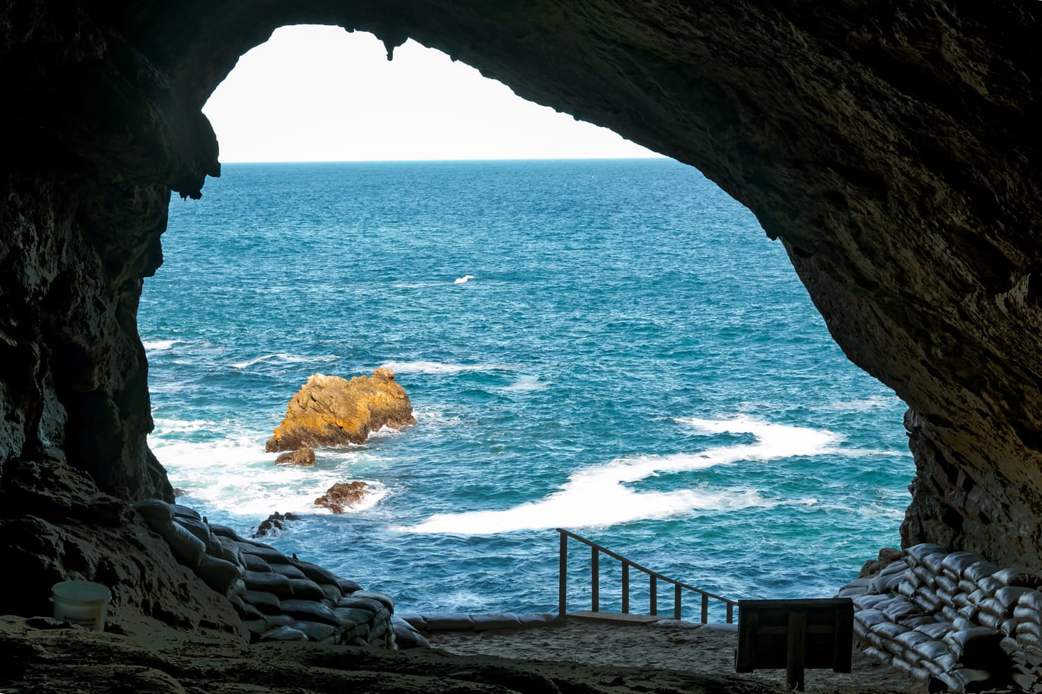 A sea cave opening onto the southern coast — a frame by the man this book is for.