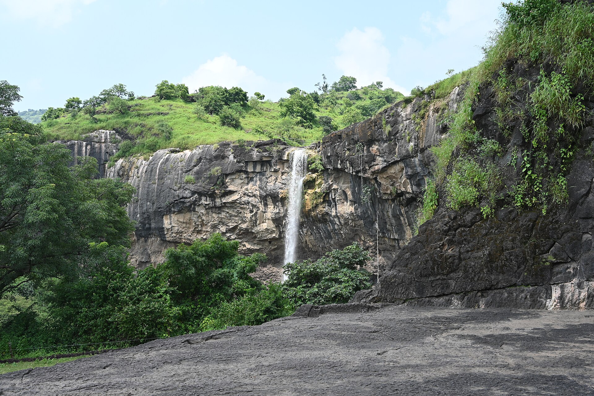 The Ellora escarpment — thirty-four caves, three faiths, one mountain.
