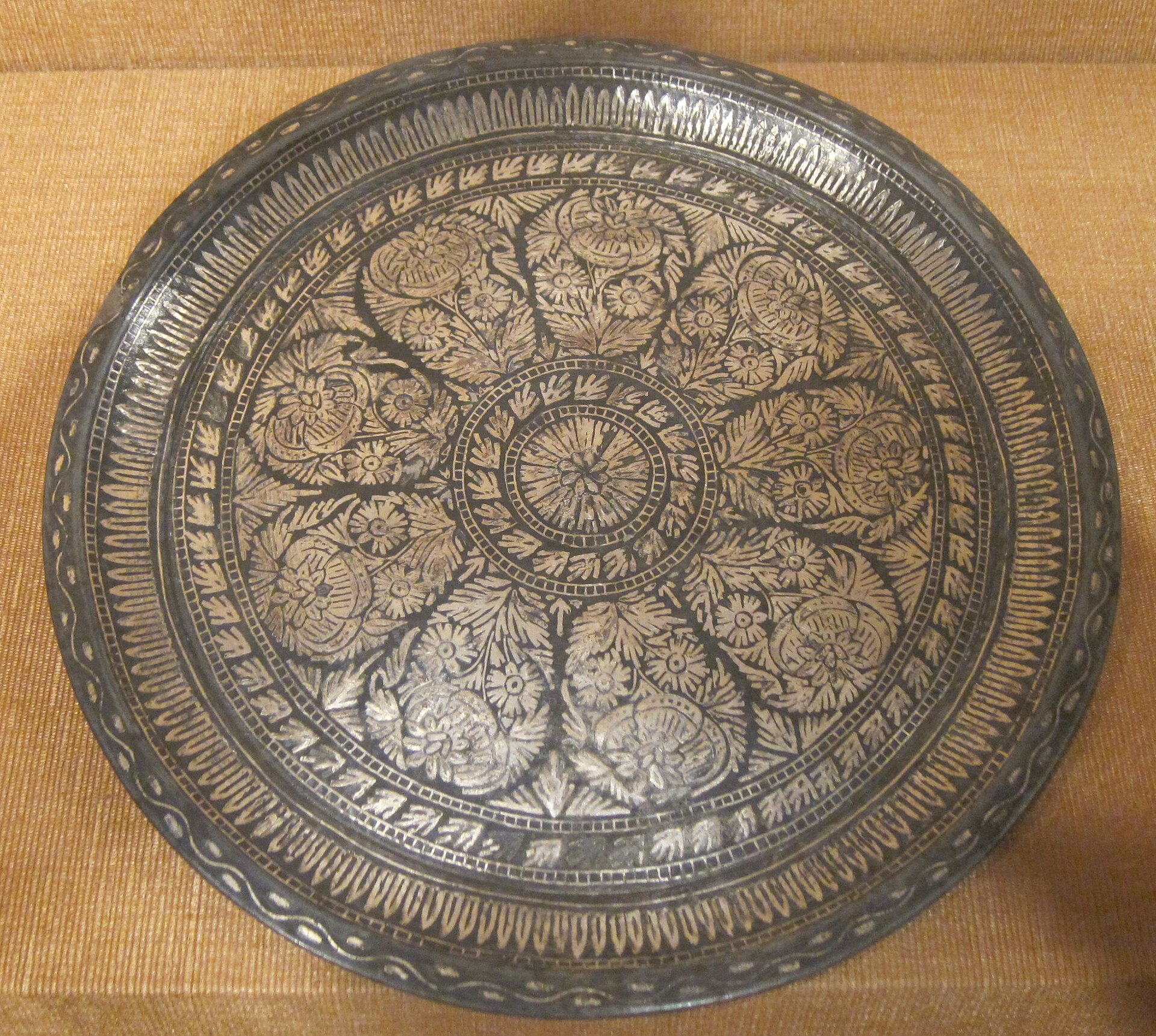 Bidriware — silver inlaid in black zinc alloy; Persian motifs, Indian hands.