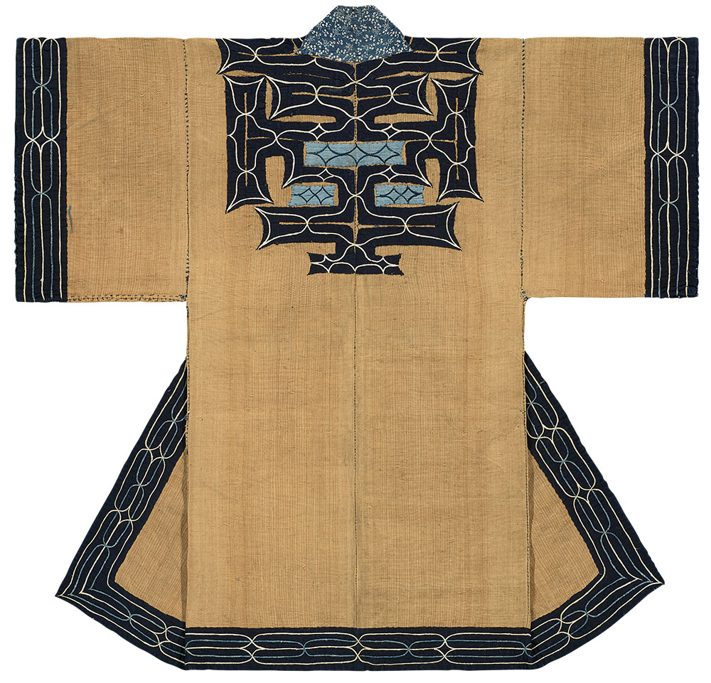 An attus elm-bast robe with moreu swirl appliqué — woven and cut by Ainu women.
