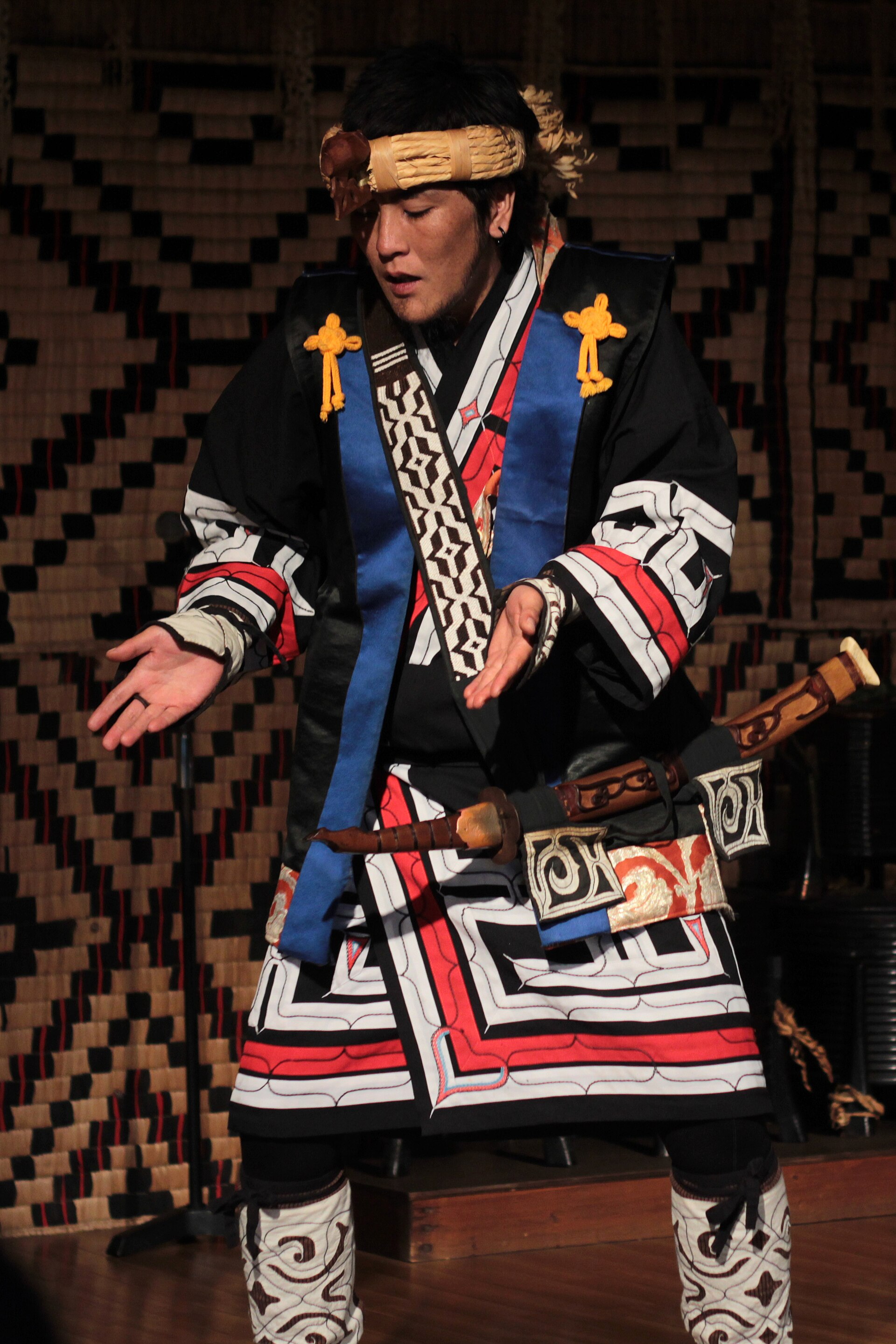 Ainu people in their own dress — a living culture, modern and self-determining, not a relic.
